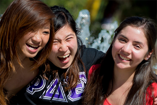 Three students laughing